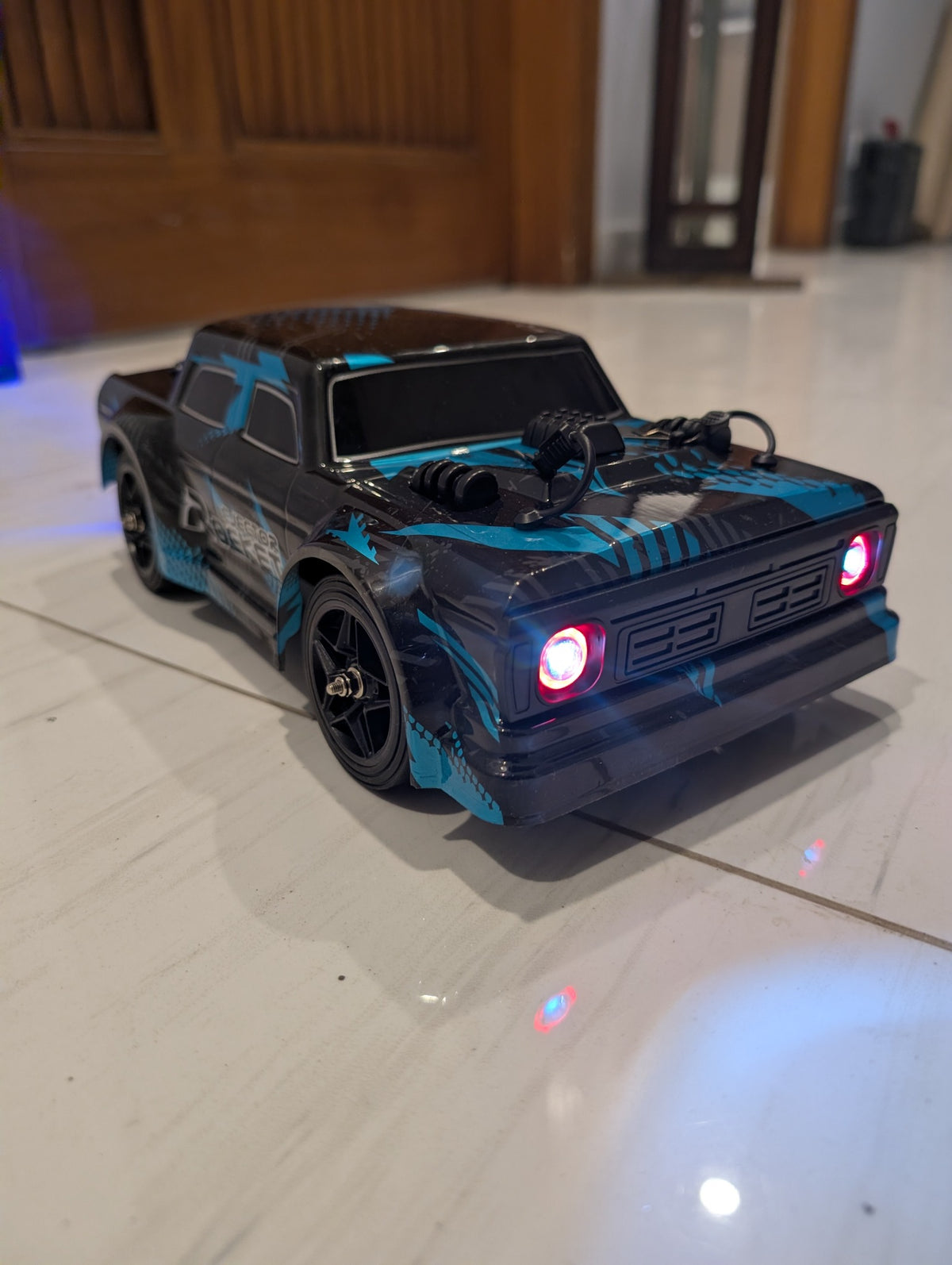 Original blue and black HISPEED RC pickup with headlights illuminated