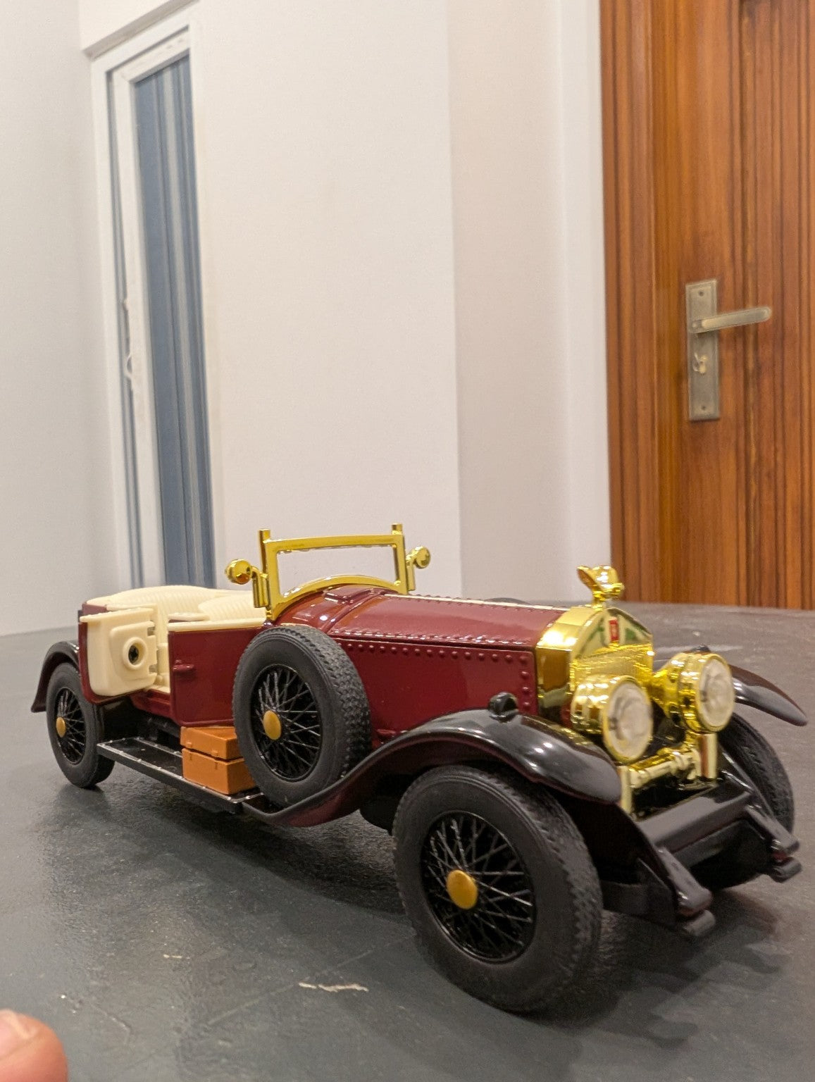 Burgundy 1:32 vintage diecast model car, front three-quarter view